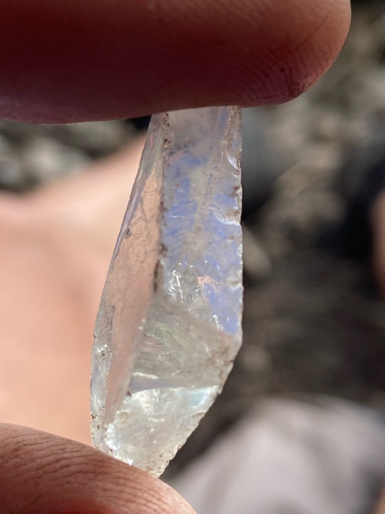 The specimen shown in the image is not a diamond; it appears to be a natural rough quartz crystal, possibly quartz or a similar clear mineral/silica-based gemstone, lacking the characteristic octahedral crystal habit and adamantine luster of rough diamond. - Rough crystal form, elongated irregular crystal habit with natural faces and fractures.