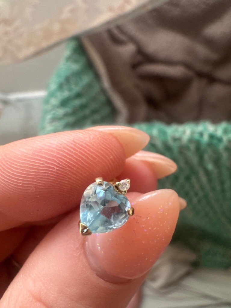 The main stone is a Semi-Precious Gemstone (likely Aquamarine or Blue Topaz); the accent stone is likely a Natural Diamond. - Heart Modified Brilliant