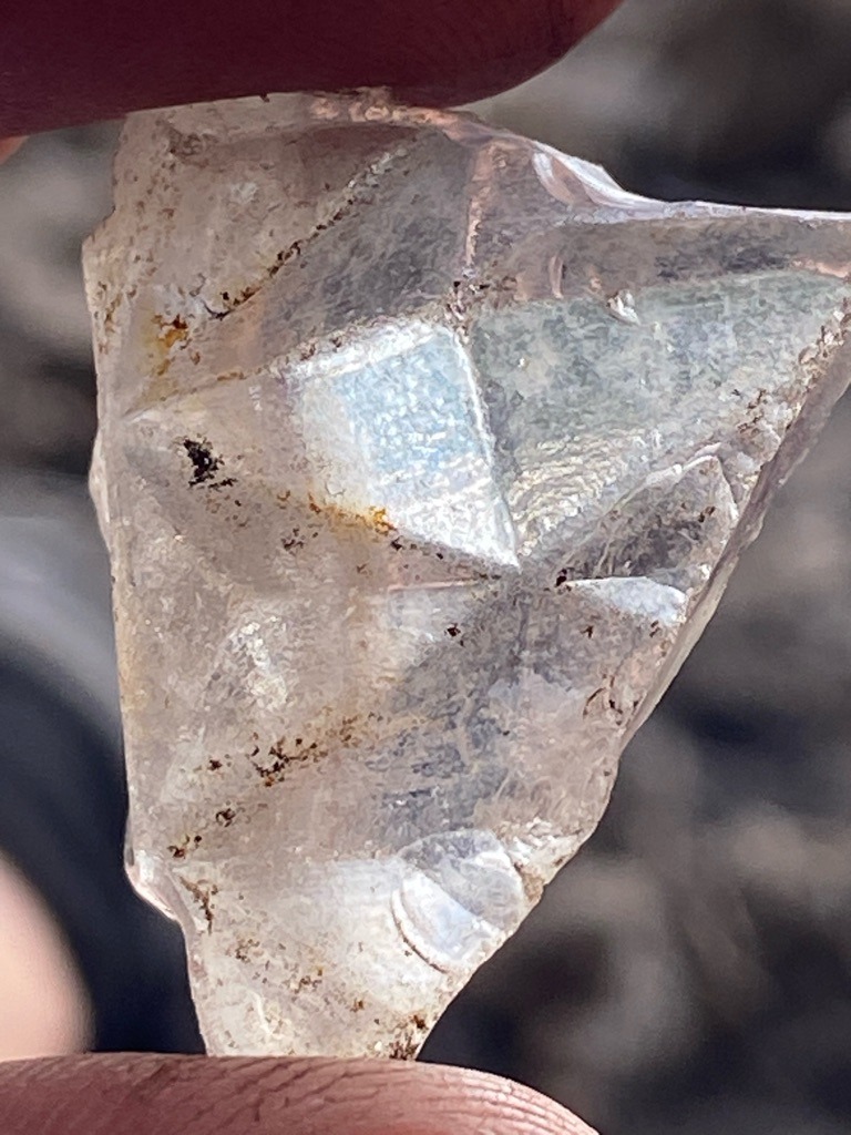 Natural rough mineral, highly likely raw quartz or potentially an uncertified rough stone rather than a gem-quality faceted diamond based on the conchoidal fracture patterns, surface etching, and inclusions visible. - Irregular rough crystal fragment, partially modified or fractured