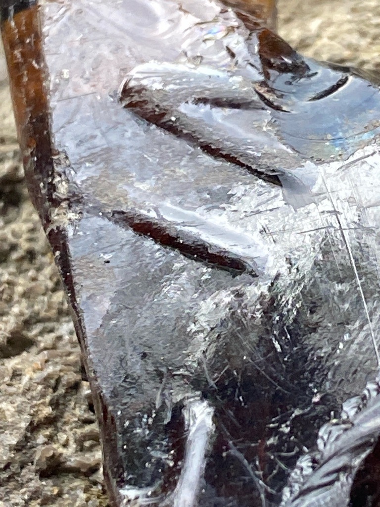 Not a diamond; appears to be industrial slag, weathered glass, or resin material with conchoidal fractures. - Irregular raw fragment / amorphous piece