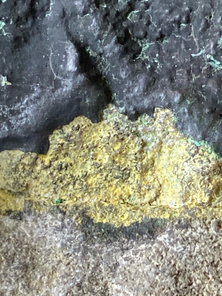 Not a diamond; the image shows mineral formations or rock matrix, possibly containing sulfur or weathered rock, but definitely not a gemstone diamond. - Not applicable