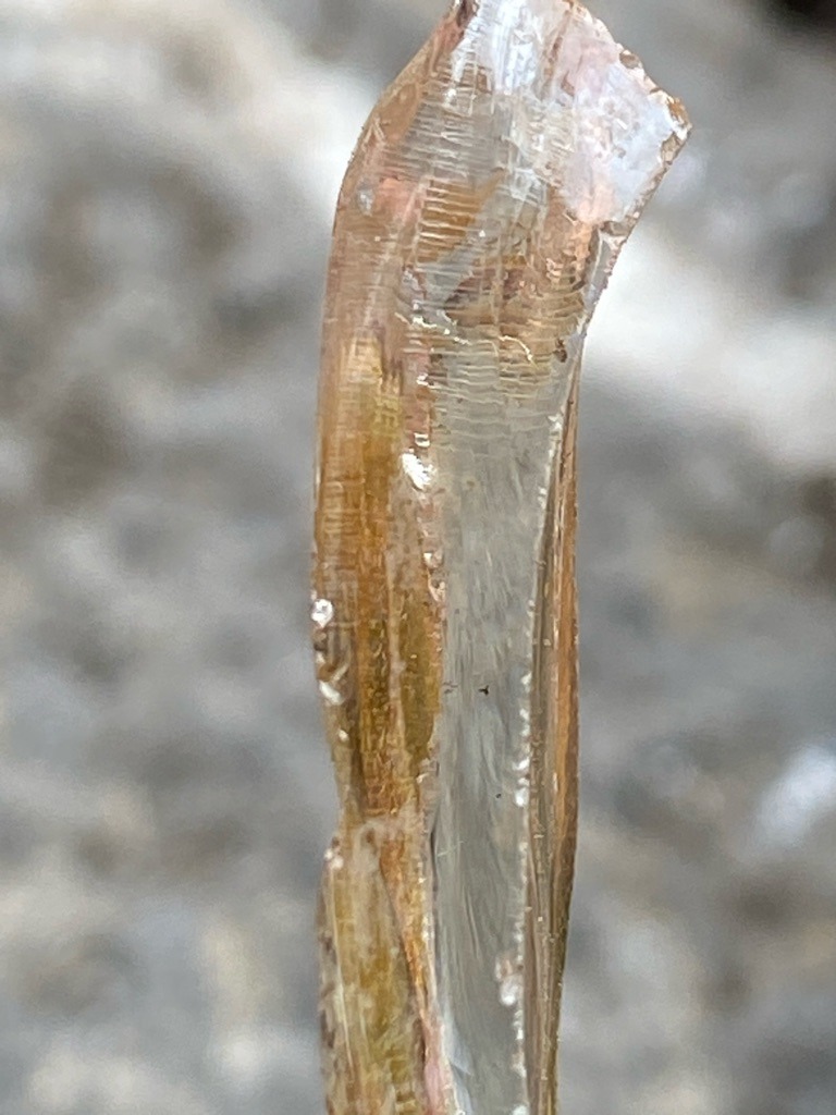 Not a diamond; this is a rough mineral crystal, likely quartz or tourmaline based on the striations and elongation. - Rough crystal form (uncut, natural crystal habit)