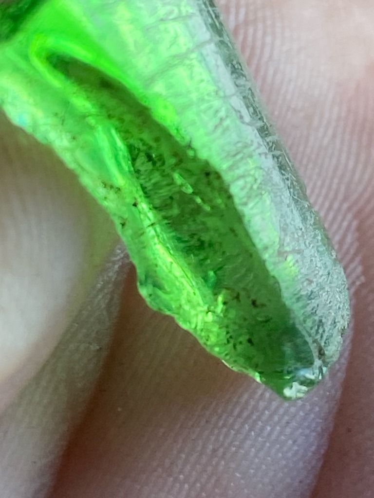 Not a diamond; this is a piece of green glass or slag material showing characteristic flow lines and bubbles. - Irregular raw fragment / unstructured