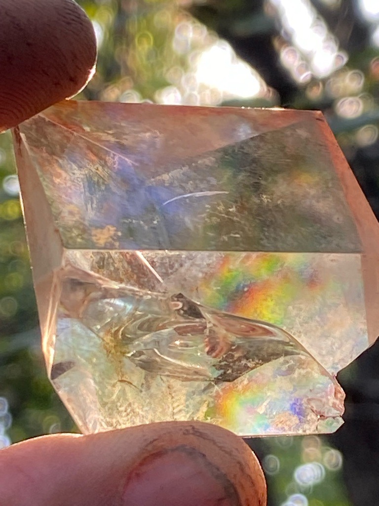 Not a diamond; this is a faceted synthetic or treated quartz / glass piece showing intense iridescent thin-film interference (often marketed as mystic quartz or treated quartz, or possibly lead crystal/glass). - Custom faceted square/rectangular block (not a standard gemstone cut)