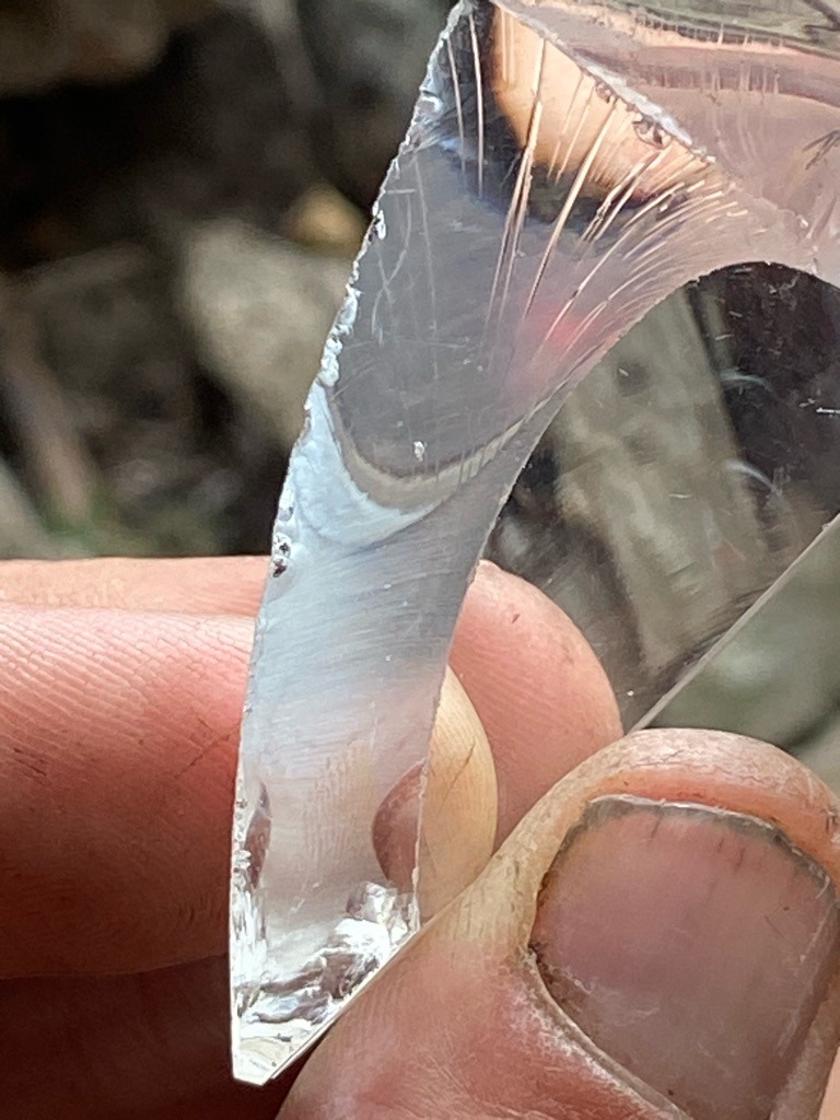 Not a diamond; this is a piece of manufactured glass or quartz showing distinct conchoidal fracture marks and striations. - Irregular fragment
