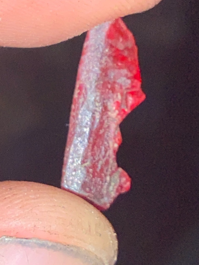 Not a diamond; this specimen appears to be a heavily fractured, opaque red rough mineral or crystal, potentially colored quartz, jasper, or resin/plastic rather than gem-quality carbon crystal. - Irregular rough shard / fragment with no standard faceted gemstone shape.