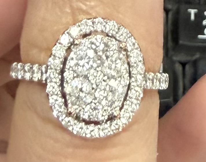 Natural (likely composite/cluster design using small melee diamonds) - Oval Halo (comprised of small round brilliant melee diamonds)