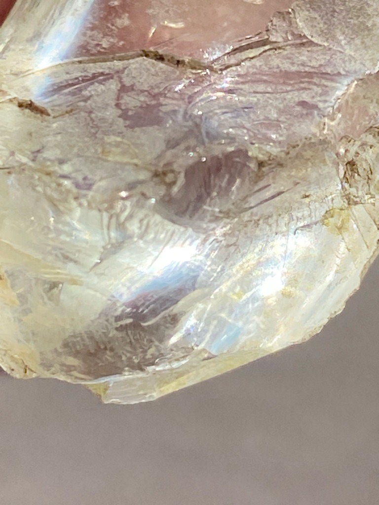 Not a diamond; this specimen appears to be an uncut rough mineral crystal, possibly quartz or another silicate, exhibiting natural fracture planes and inclusions rather than diamond characteristics. - Rough, uncut crystal with natural irregular formation