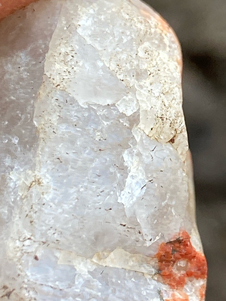 Not a diamond; this is a raw mineral matrix showing crystalline quartz interspersed with iron oxide or hematite staining. - Rough uncut matrix / irregular crystalline aggregate