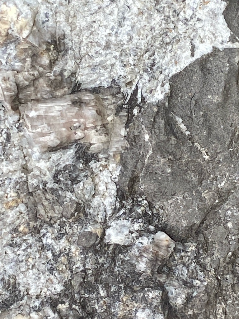 Not a diamond / Host rock matrix (likely pegmatite or kimberlitic host rock containing feldspar/quartz) - Rough crystal / Uncut matrix
