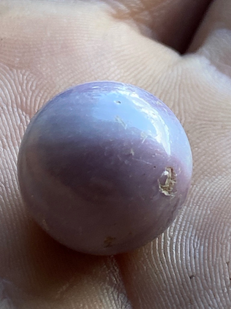 Not a diamond; visual characteristics and spherical cabochon shape strongly resemble a natural mineral bead such as Kunzite, Lepidolite, or tinted quartz rather than diamond. - Spherical Bead / Cabochon