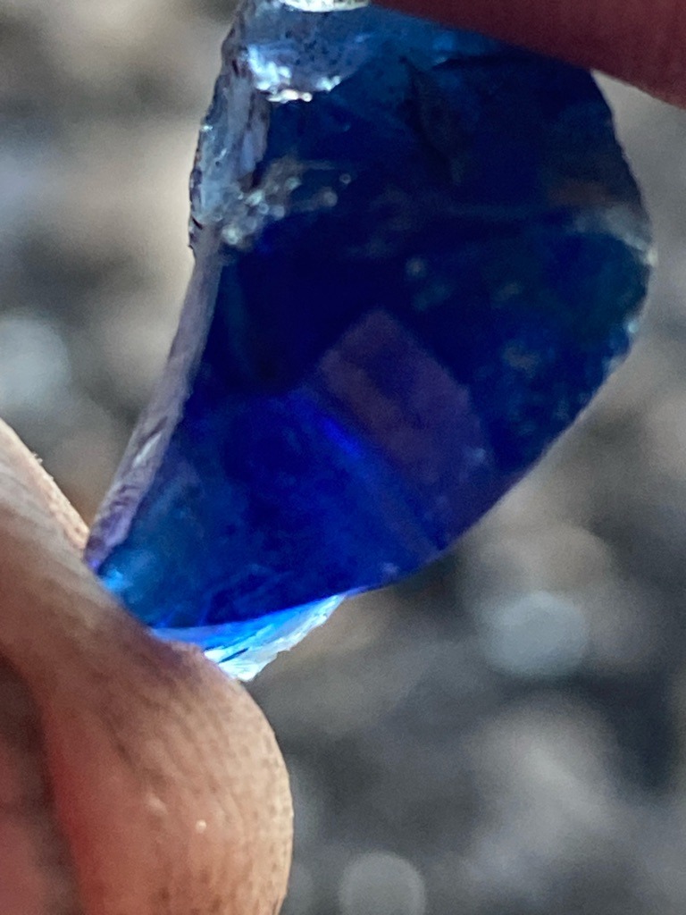Not a diamond; this specimen appears to be a raw or heavily fractured piece of blue glass or potentially a low-grade rough gemstone like blue quartz, sapphire, or slag glass rather than diamond. - Irregular raw rough / uncut crystal fragment