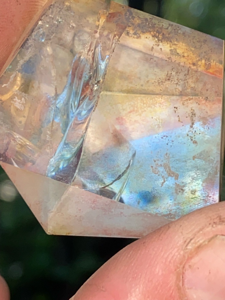 Not a diamond; this specimen is visibly synthetic or treated quartz, commonly known as Aqua Aura or Mystic Quartz, created via chemical vapor deposition of metal oxides onto a natural or synthetic quartz crystal. - Rough crystal / Modified faceted hexagonal prism form with irregular cut elements.