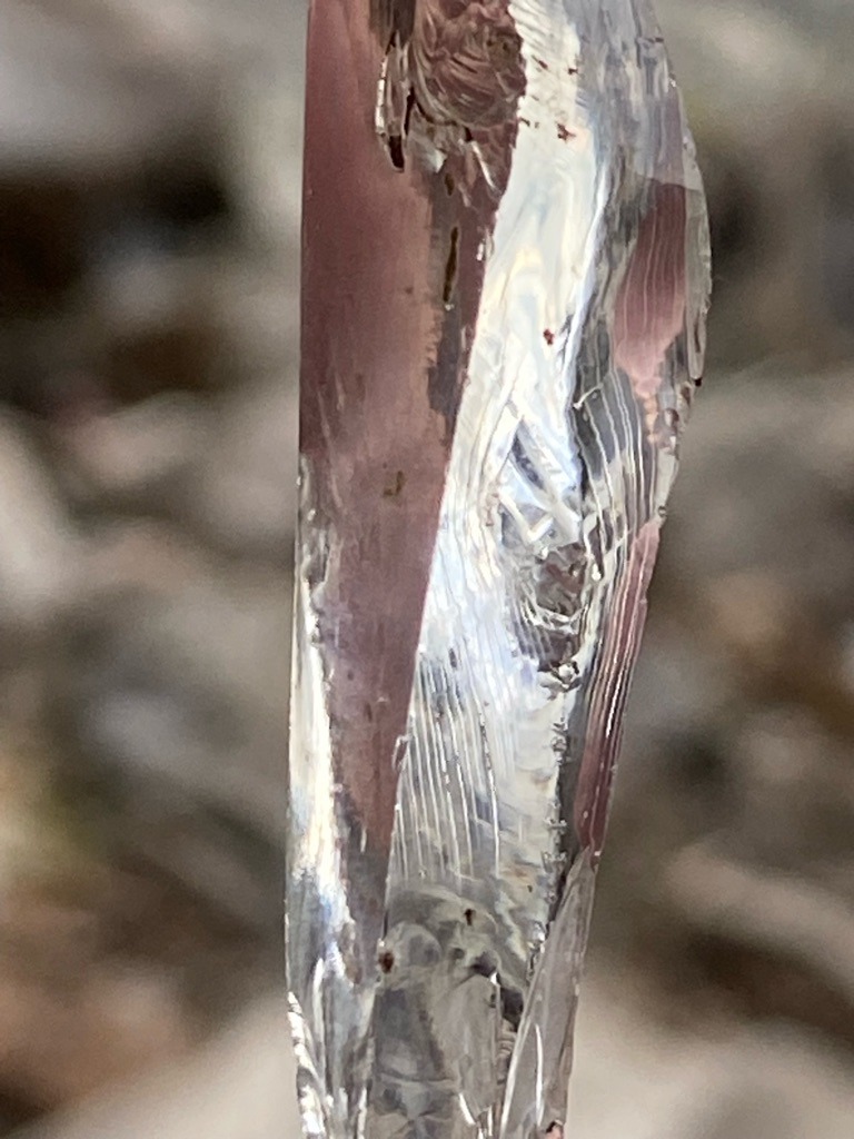 Not a diamond; appears to be an icicle or glass shard based on visual texture and context. - Irregular elongated formation