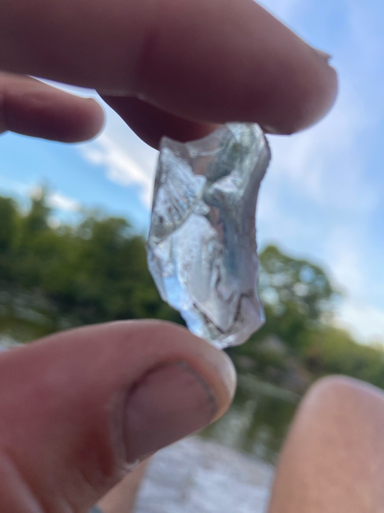Not a diamond; appears to be a piece of broken glass or quartz crystal - Irregular raw fragment / amorphous shard