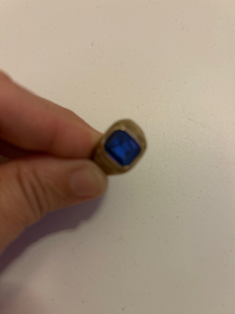 Not a diamond; this gemstone appears to be a blue sapphire or a synthetic blue spinel set in a ring. - Cushion / Rectangular step cut with rounded corners