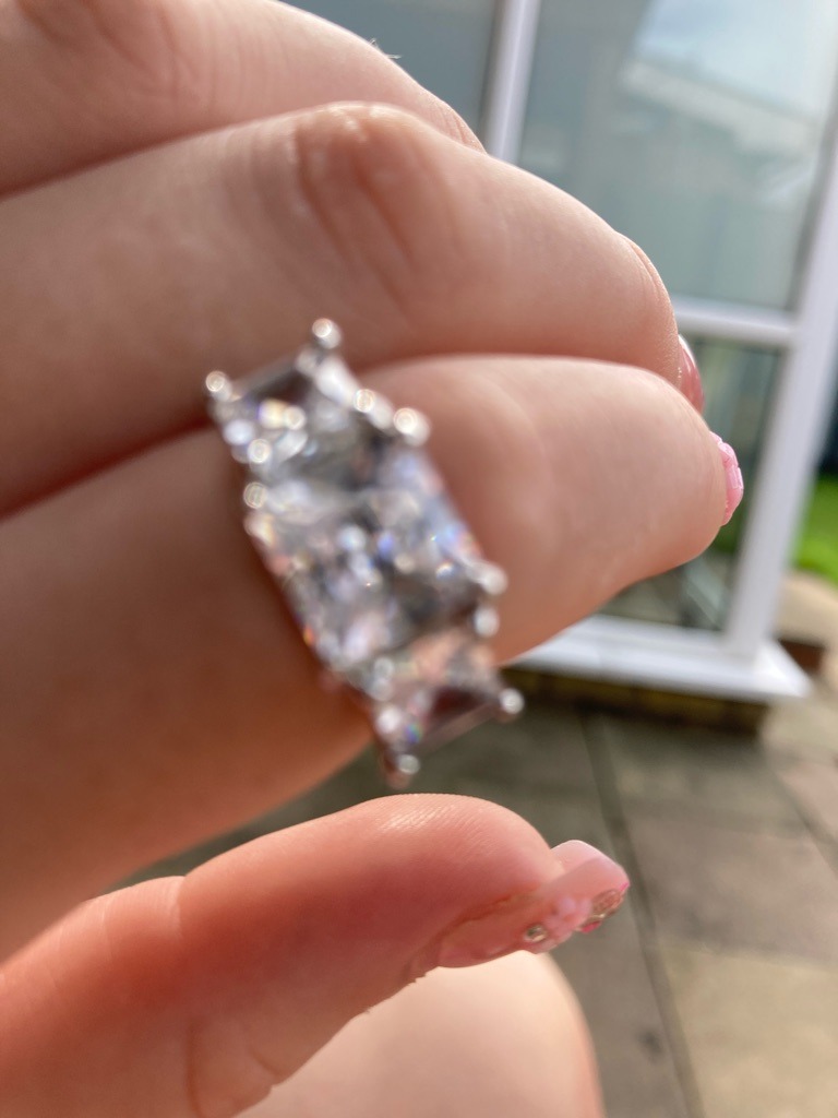 Natural Diamond (Assumed based on typical jewelry presentation, though definitive lab verification is required) - Radiant Cut (with elongated rectangular proportions)