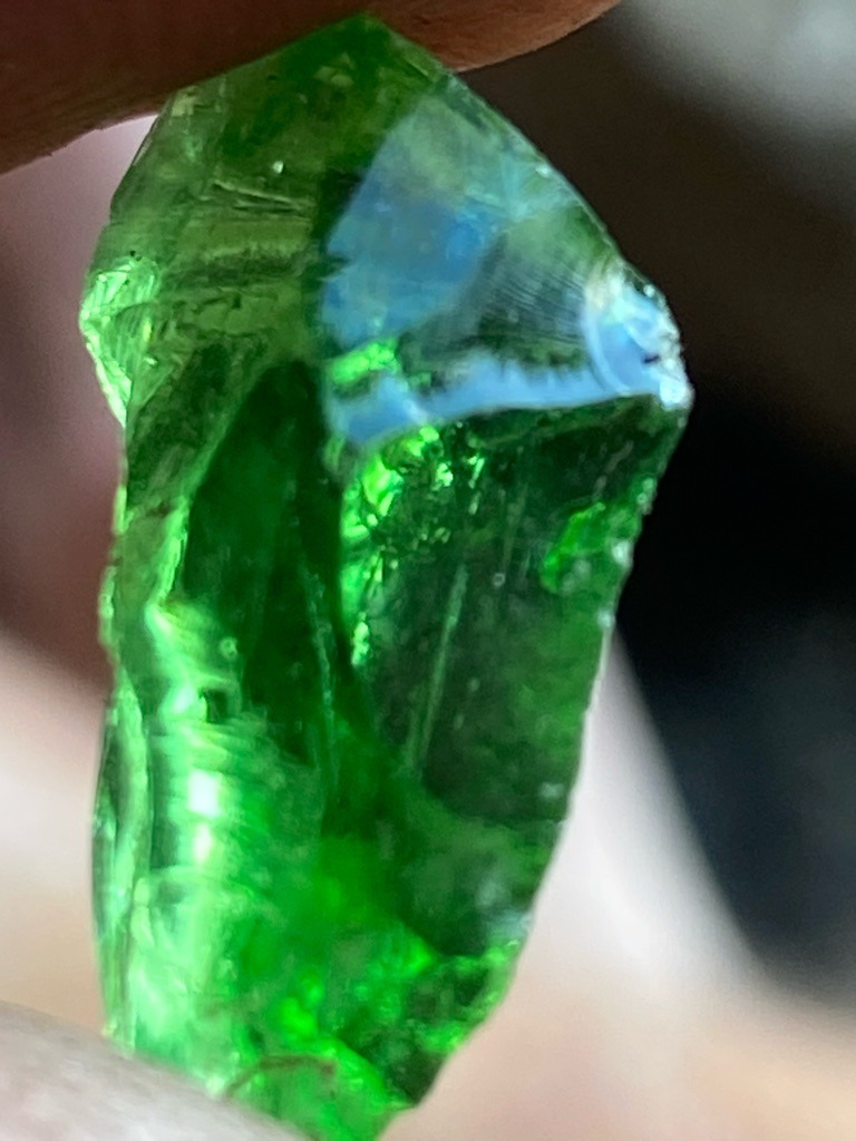 Not a diamond; this specimen exhibits characteristics typical of green glass, slag glass, or potentially a rough green crystal such as emerald or tourmaline, but visual inspection strongly suggests green glass or synthetic material. - Raw, uncut, amorphous or irregular crystal/fragment shape with conchoidal fractures.