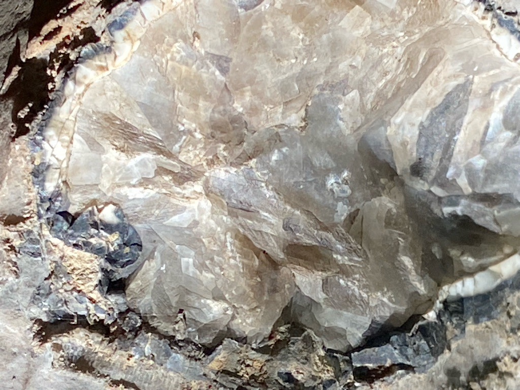 Not a diamond; this image depicts raw crystalline rock formation, likely calcite or quartz within a geode matrix, rather than a faceted gemstone. - Rough crystalline aggregate / unshaped matrix