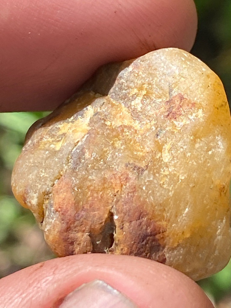 The specimen shown in the image is not a diamond; it appears to be a rough quartz pebble, likely heavily stained with iron oxide (hematite/limonite). - Irregular / Rough Pebble
