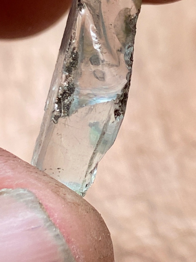 Not a diamond; appears to be raw quartz or glass slag based on the irregular elongation, conchoidal fracture, and lack of crystal faces. - Uncut raw crystal fragment / Irregular elongated shard
