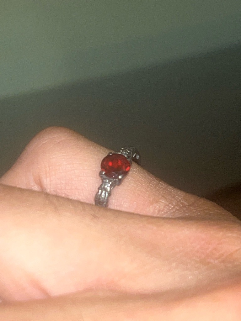 Not a diamond; this gemstone appears to be a red stone such as a ruby, garnet, or red spinel set in a dark or oxidized metal band. - Round / Oval mixed cut