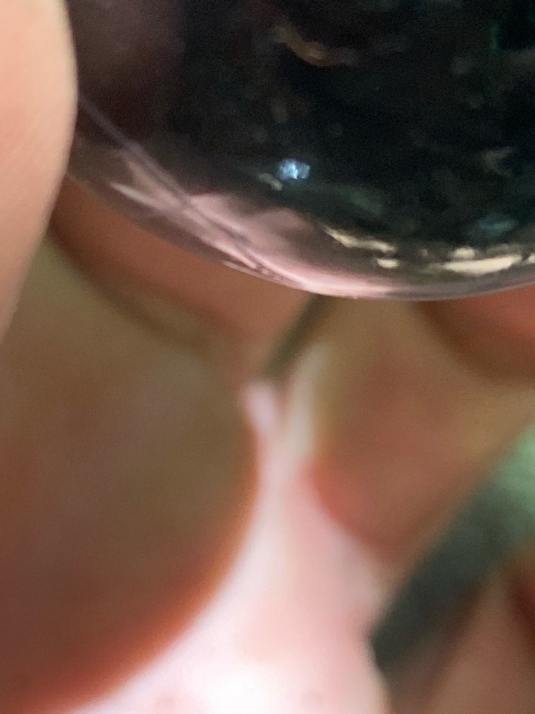 Unable to definitively determine from the provided image due to extreme blur, obstruction, and inadequate lighting conditions. - Undetermined due to severe image obstruction and lack of clear facet visibility.