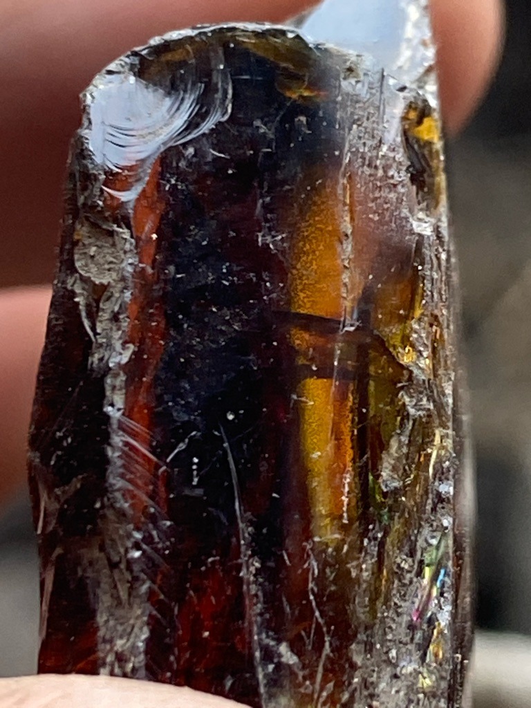 Not a diamond; this specimen appears to be industrial slag glass, obsidian, or heavily fractured amber/resin with conchoidal fracturing. - Rough uncut irregular mass / raw chunk with conchoidal fracture patterns