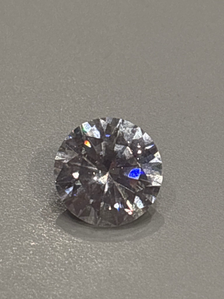 Natural Diamond (or potentially Lab-Grown, requires advanced testing to confirm definitively) - Round Brilliant