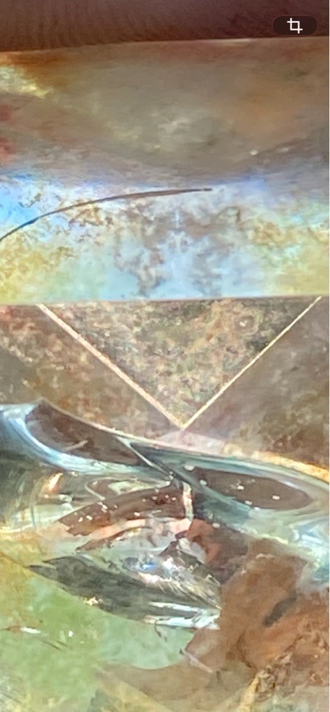 The provided image does not clearly show a loose or mounted diamond with sufficient detail for a definitive gemological analysis. It appears to be a distorted or abstract reflection, possibly glass or a reflective surface, rather than a genuine diamond. - Unable to determine due to lack of a clear, identifiable diamond in the image.