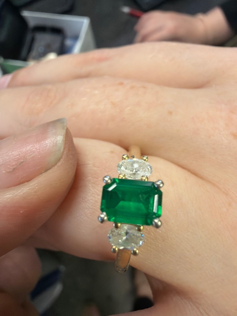 Natural Diamond (accent stones) and Emerald (center stone) - Oval (accent diamonds) and Emerald Cut (center emerald)
