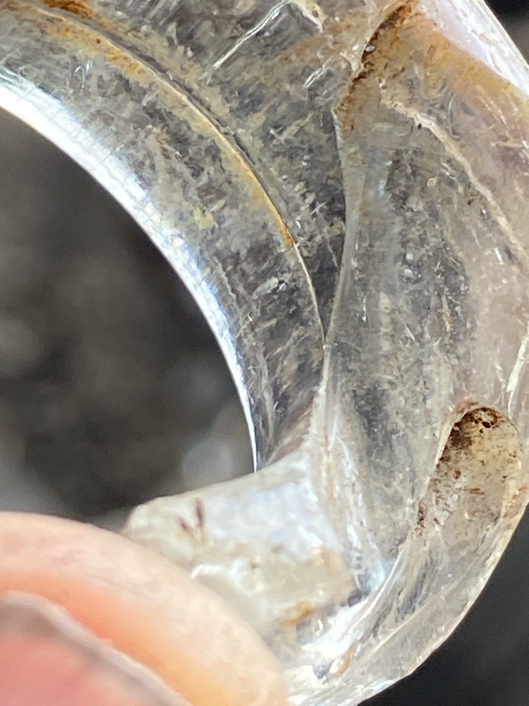 Not a diamond; appears to be quartz, rock crystal, or a similar silicate mineral carved into a ring or artifact. - Irregular carved or curved shape (artifact/ring band)