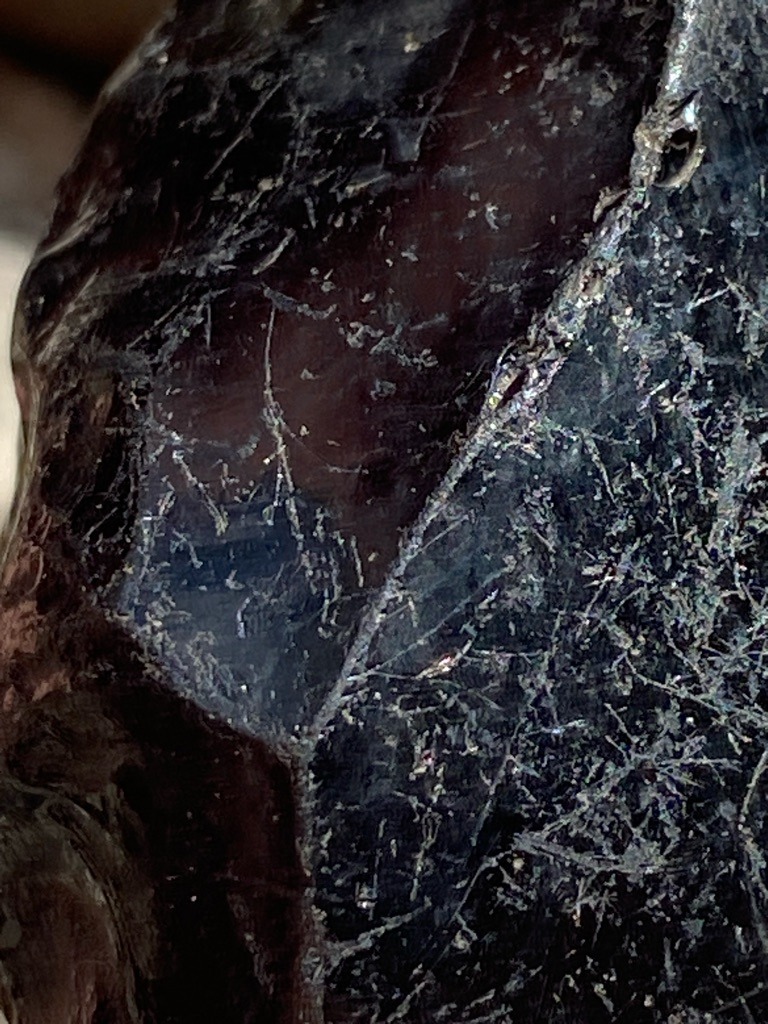 Not a diamond; this image displays rough or altered mineral material, possibly carbonado or industrial aggregate, but lacks standard diamond crystal morphology or faceting. - Uncut or rough irregular crystalline mass