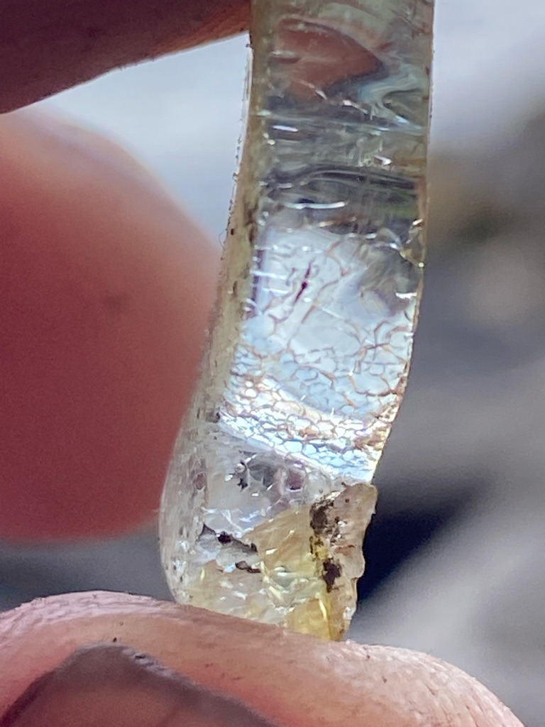 Not a diamond; this object appears to be a piece of fractured quartz, glass, or similar crystalline/silicate material, showing distinct internal thermal shock fractures and conchoidal breaks. - Irregular raw fragment or shard