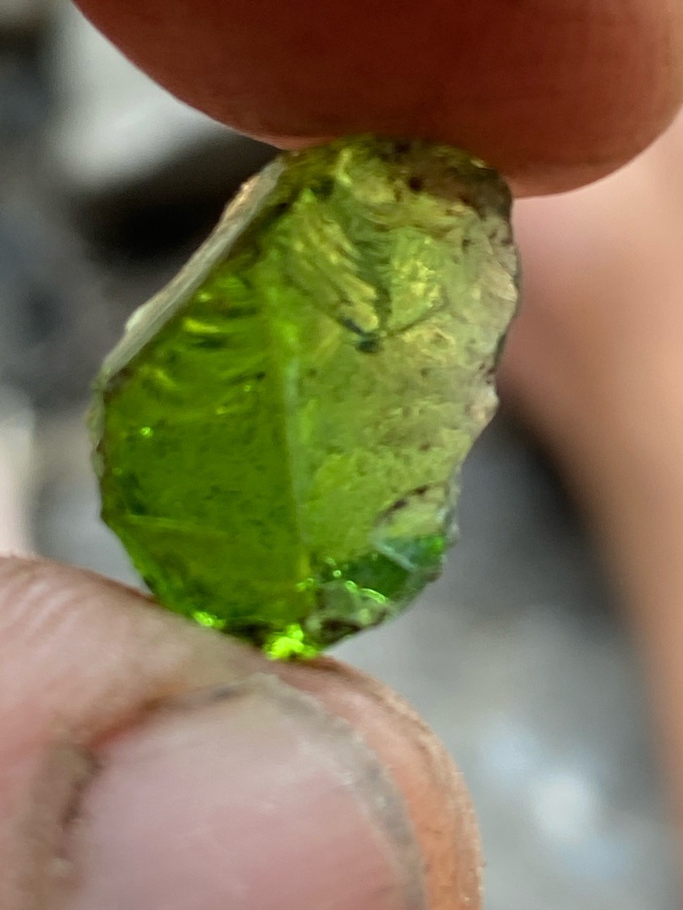Not a diamond; this is a rough green gemstone, likely Peridot or rough green glass/slag, given the characteristic olive-green color and conchoidal fracture pattern. - Rough / Uncut, irregular rounded crystal fragment