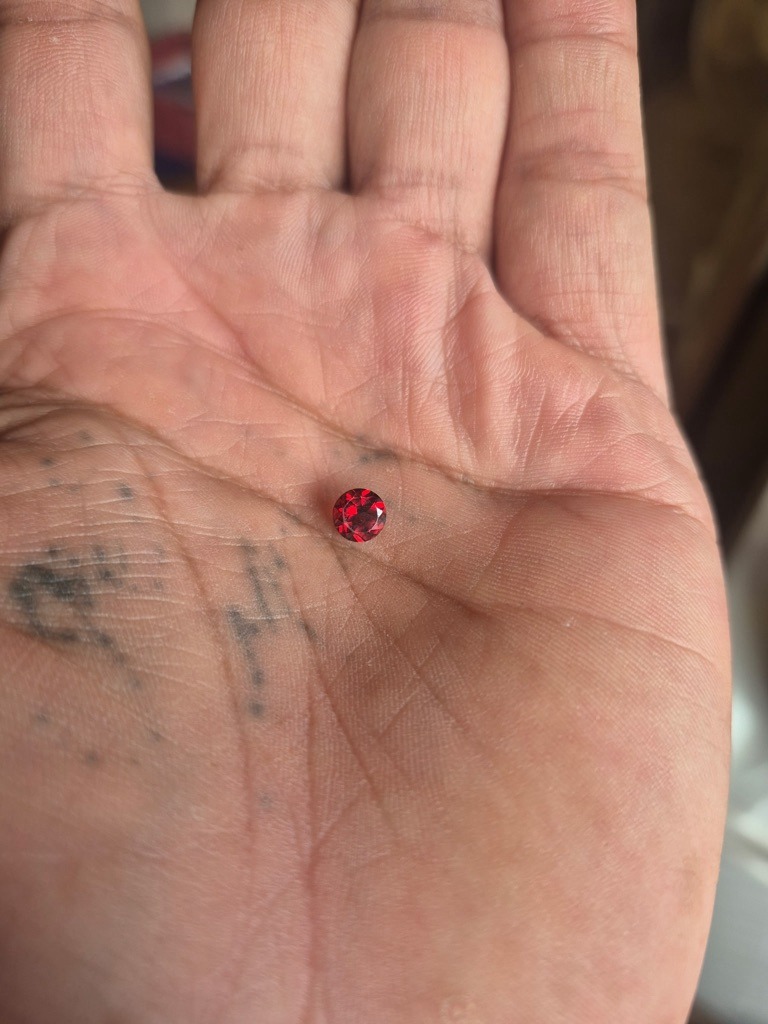 Natural Fancy Red Diamond (or potentially a treated ruby/garnet based on visual impression, but assuming gem-grade red diamond for standard scale analysis) - Round Brilliant