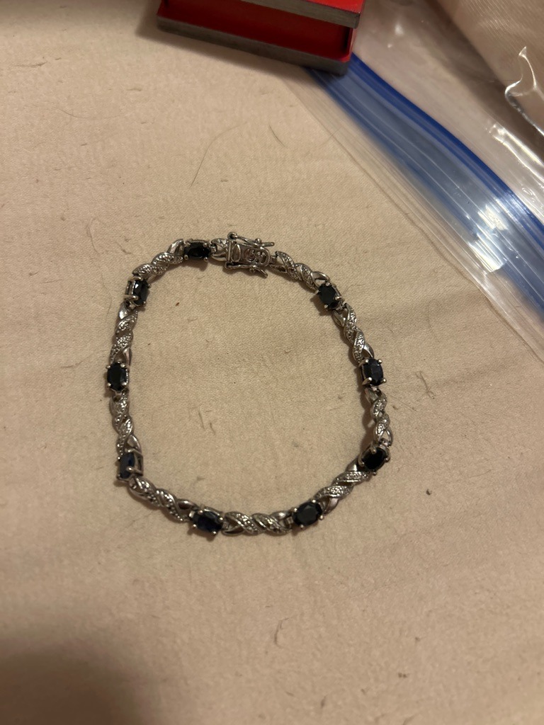 Natural (accent stones), likely combined with natural sapphires or dark gemstones - Round Brilliant (accent melee) / Oval (centerstones)