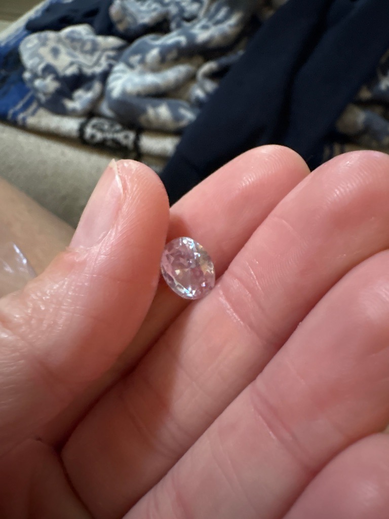 Likely diamond simulant (such as Cubic Zirconia or Moissanite) due to visual dispersion characteristics, or potentially a lab-grown diamond requiring further physical testing. - Oval Brilliant