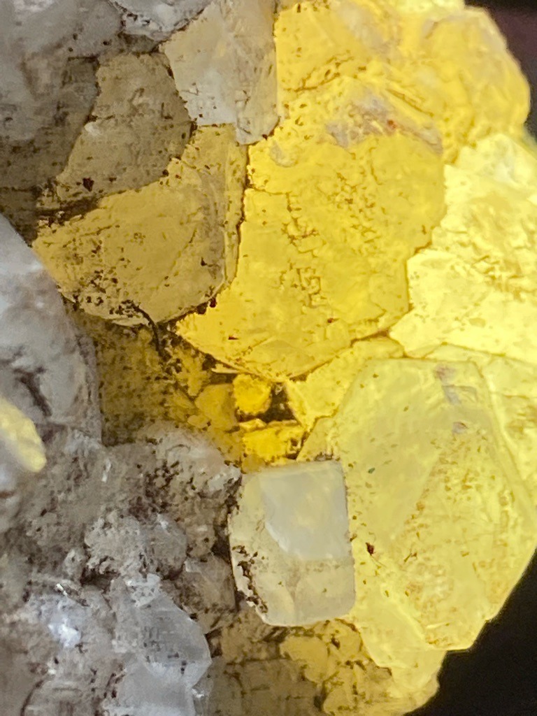Not a diamond; the image displays raw mineral crystals, likely yellow sulfur or calcite associated with matrix rock, entirely distinct from gem diamond. - Rough crystal habit / Untouched crystalline formation