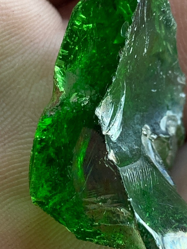 Not a diamond; this specimen appears to be green glass or a green mineral aggregate (such as green quartz, glass slag, or rough tsavorite garnet), lacking the characteristic cubic crystal habit, high refractive index, and adamantine luster of diamond. - Raw, unpolished rough crystal fragment with conchoidal fracture typical of glass or quartz.