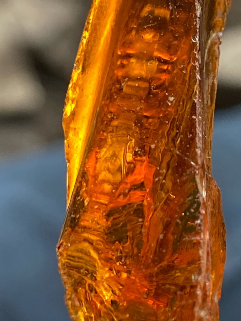Not a diamond; this is a piece of amber or possibly a resinous organic material exhibiting strong natural irregular growth patterns and deep orange-brown coloration. - Rough, uncut, irregular elongated nodule or fragment.
