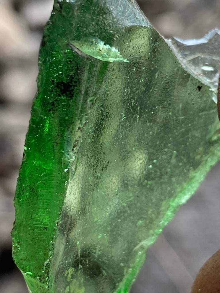 Not a diamond; this is green glass or slag glass, commonly referred to as sea glass or bottle glass. - Irregular raw shard, unshaped/uncut