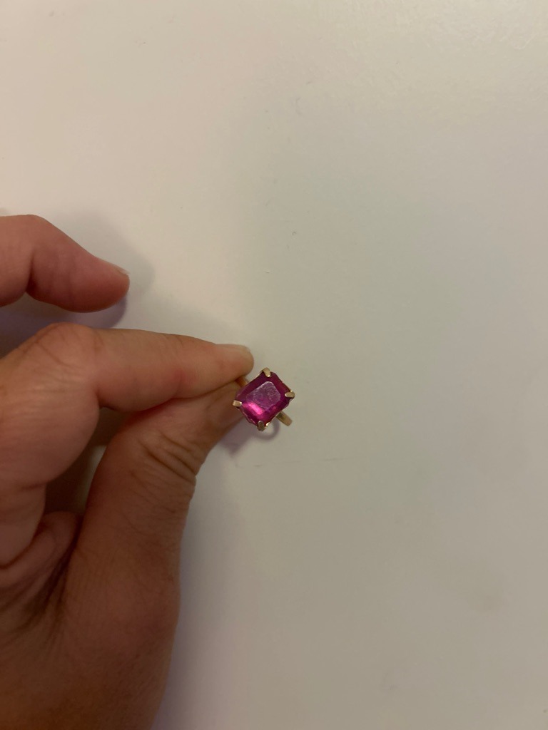 Not a diamond; likely a colored gemstone such as pink sapphire, tourmaline, or synthetic spinel set in a yellow gold ring. - Asscher or Square Emerald Cut