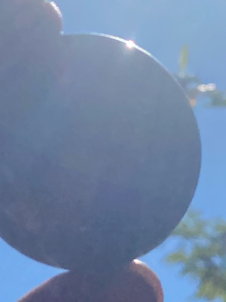 Unable to definitively determine diamond type from this silhouette-style photograph, as internal and optical characteristics are heavily obscured by backlighting against the bright sky. - Round