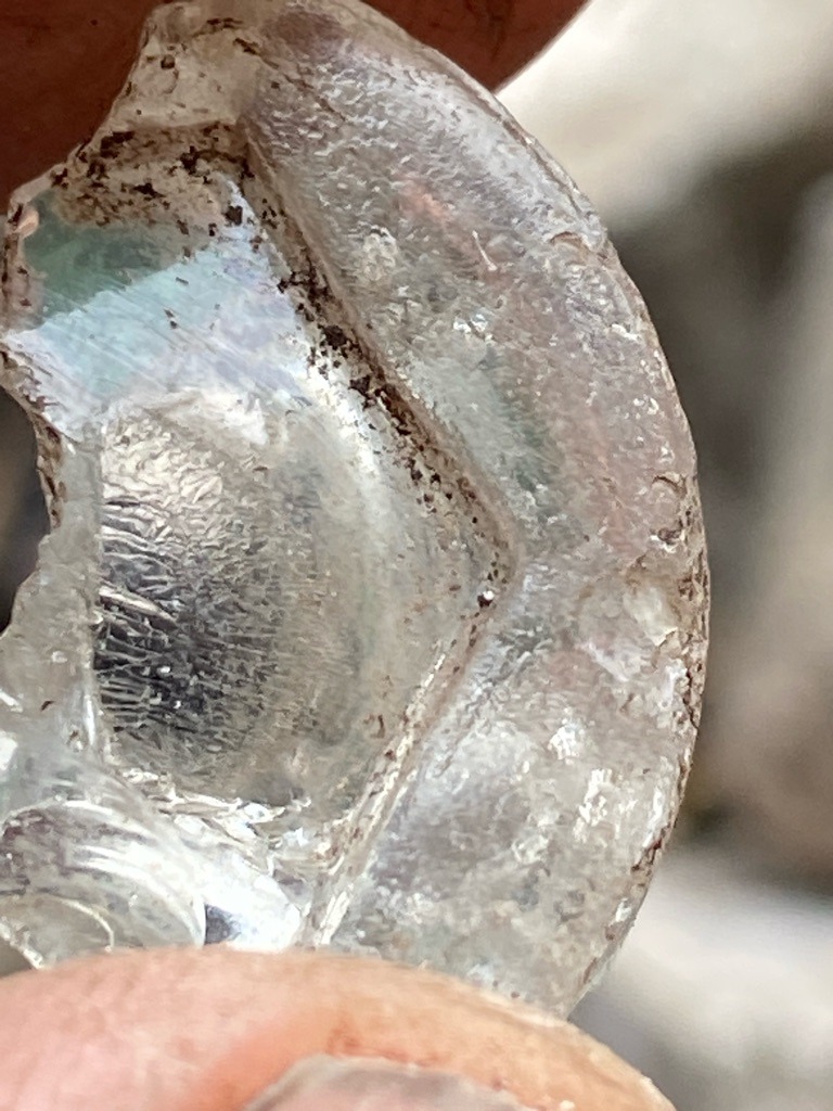 Not a diamond; this appears to be a fragment of weathered or tumbled glass / quartz artifact, showing typical conchoidal fracture and surface wear. - Irregular / Fragment