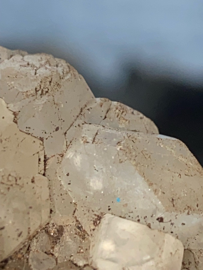 Not a diamond; appears to be crystalline quartz or a similar silicate mineral matrix with embedded debris. - Rough crystal form / irregular crystal habit