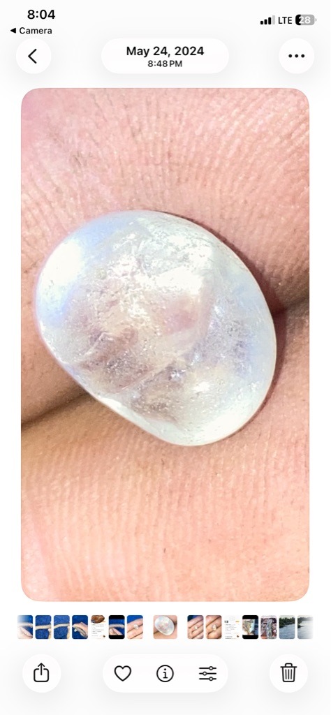 Not a diamond; visual characteristics strongly suggest a pearl, moonstone, or coated quartz/glass cabochon rather than a genuine diamond. - Irregular Cabochon / Oval Cabochon