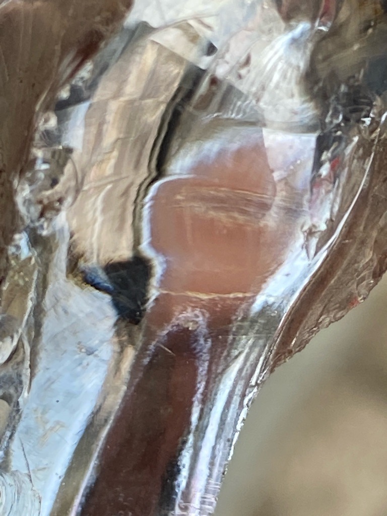 Not a diamond; likely quartz, glass, or rough mineral fragment due to irregular conchoidal fracture patterns. - Raw, uncut, amorphous crystal fragment.