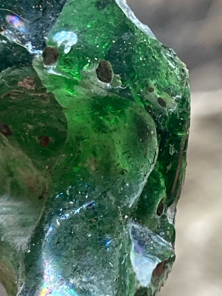 Not a diamond; this is a piece of green glass, possibly industrial slag or recycled glass, displaying conchoidal fracture and gas bubbles. - Raw, uncut, and unpolished irregular shard with conchoidal fracture patterns.