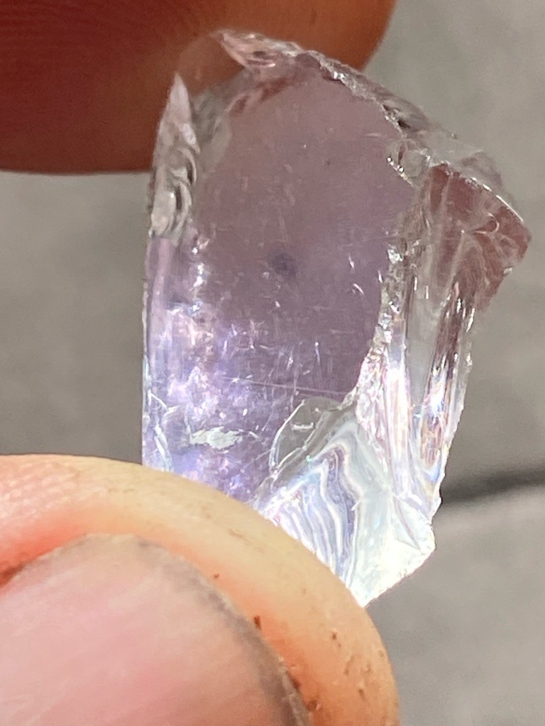Not a diamond; appears to be raw quartz, kunzite, or colored glass/slag with surface iridescence - Rough crystal / Irregular uncut fragment
